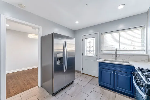 a kitchen with stainless steel appliances granite countertop a refrigerator and a sink