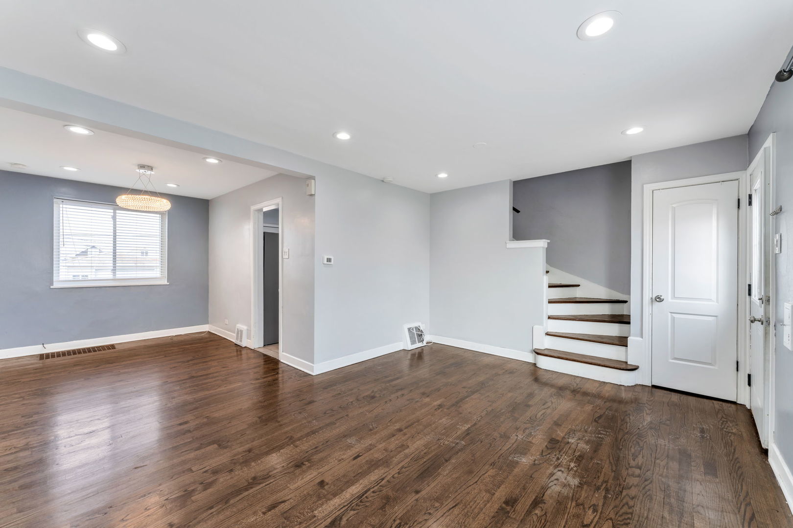 3142 54th Court Cicero, IL 60804 - Photo 5 of 15 a view of an empty room with a window and wooden floor