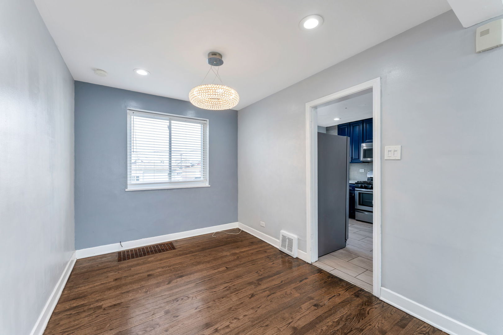 3142 54th Court Cicero, IL 60804 - Photo 7 of 15 an empty room with wooden floor and window