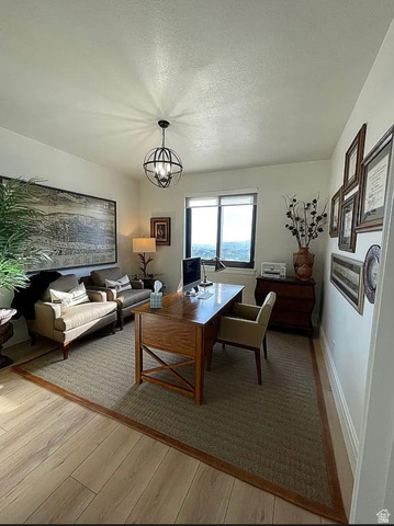 838 East Mountain Road North Ogden, UT 84414 - Photo 14 of 37 Dedicated interior space featuring wood-finish flooring, a built-in window with a roller shade, and a spherical chandelier