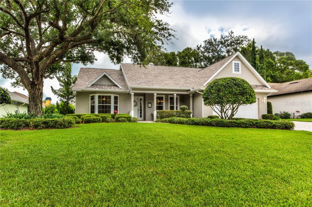 19221 Park Pl Boulevard Eustis, FL 32736 - Photo 1 of 1 a front view of a house with a garden and yard