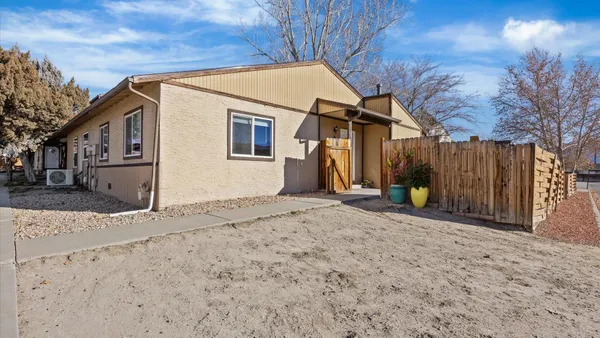 a view of a house with wooden fence