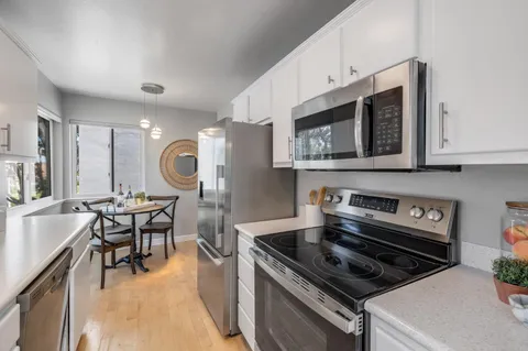 a kitchen with a stove a sink and a microwave