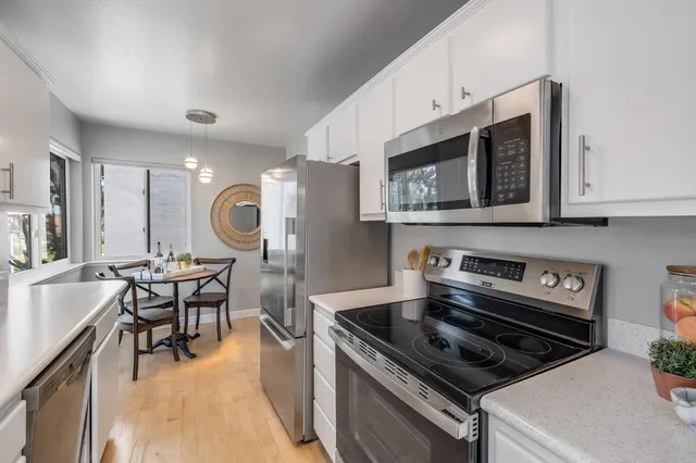 a kitchen with a stove a sink and a microwave