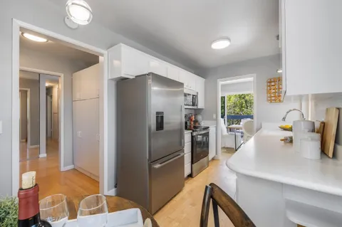 a kitchen with stainless steel appliances a refrigerator and a sink