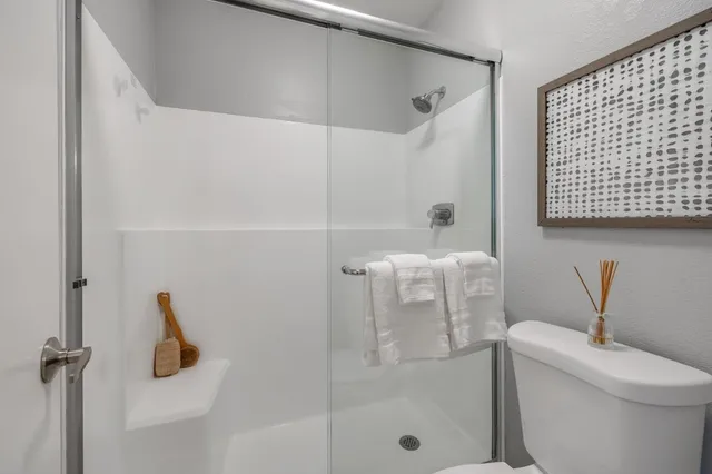 a bathroom with a toilet and a shower