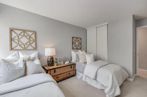 a bedroom with a bed and lamp