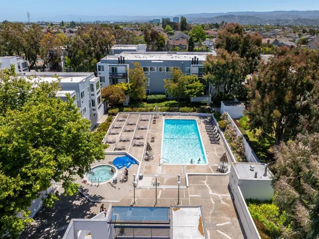 an aerial view of a house with table and chairs