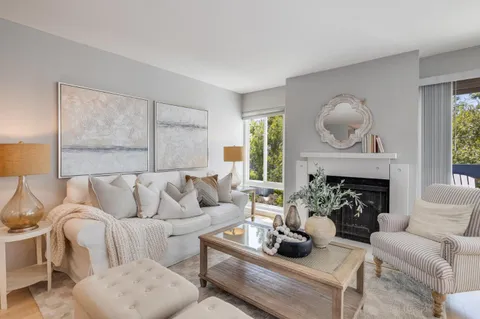 a living room with furniture fireplace and window
