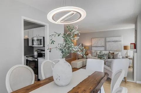 a living room with furniture a chandelier and a window