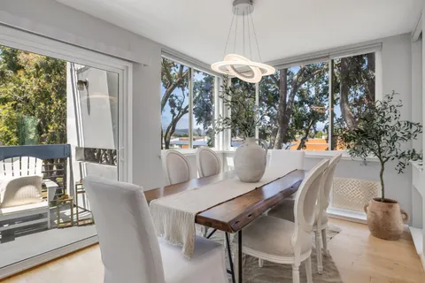 a view of a dining room with furniture window and outside view