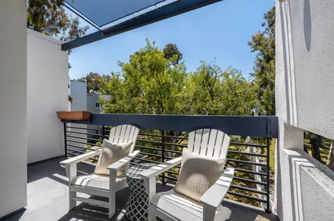 a view of balcony with couple of chairs