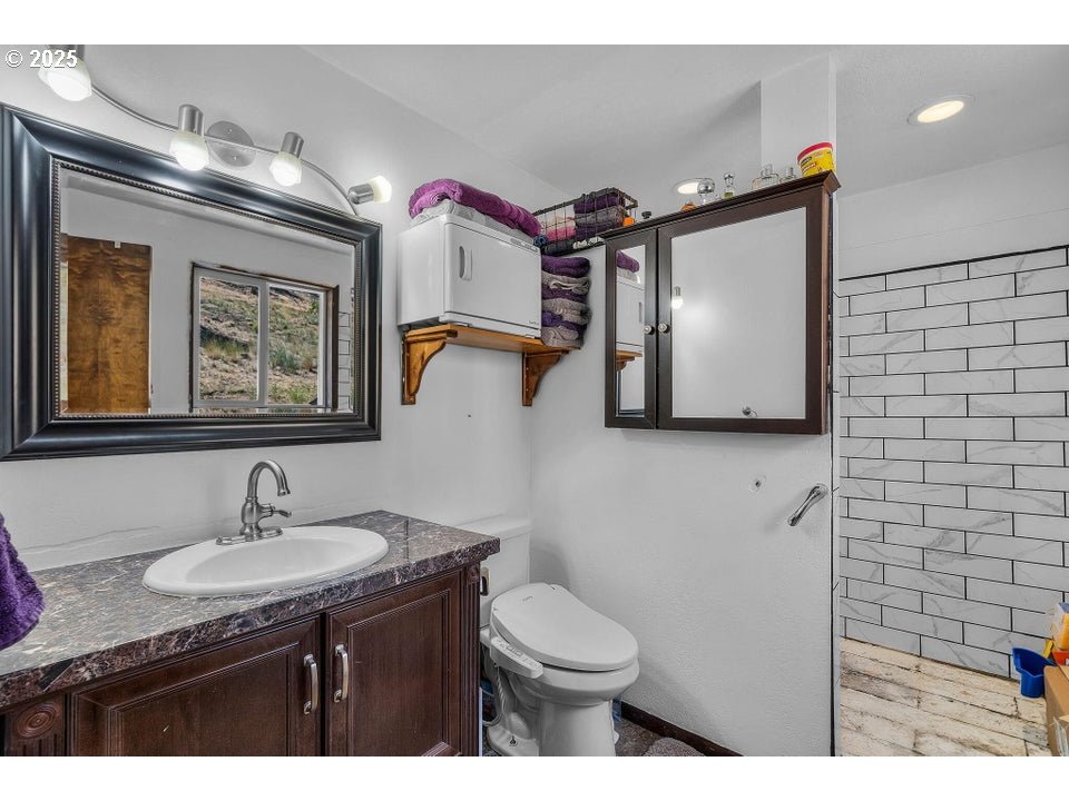 4800 Mill Creek Road Prineville, OR 97754 - Photo 17 of 40 a bathroom with a toilet sink and mirror