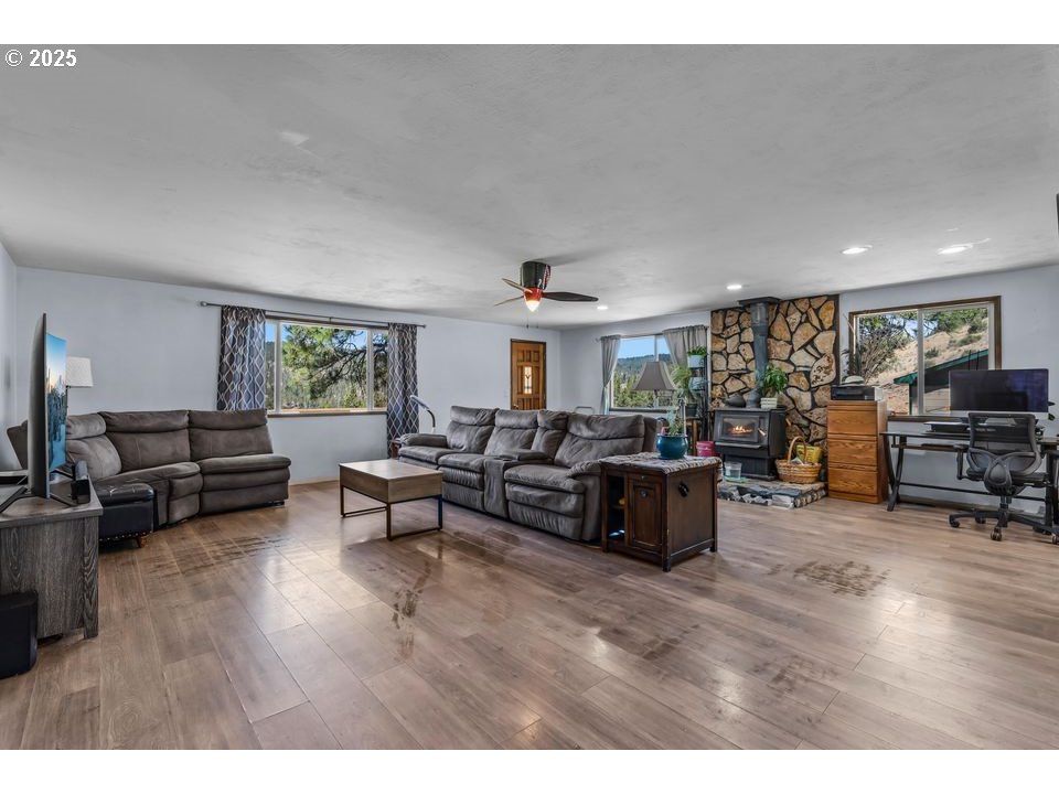 4800 Mill Creek Road Prineville, OR 97754 - Photo 7 of 40 a living room with furniture and a wooden floor