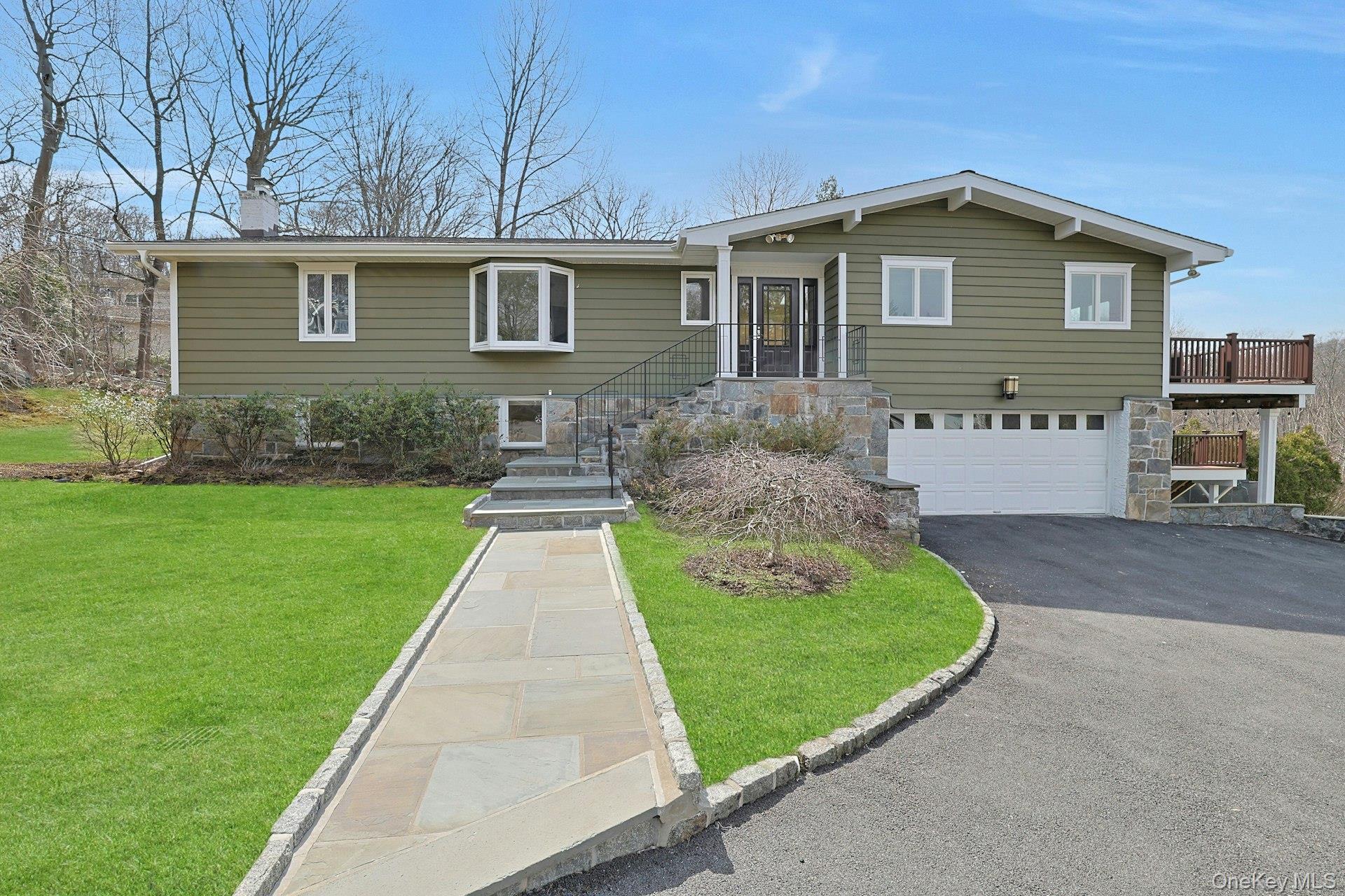 Set on nearly a full acre of beautifully landscaped property, this sun-filled contemporary home, expanded and updated in 2016, offers an exceptional sense of space, light, and privacy in the highly acclaimed Edgemont School District.