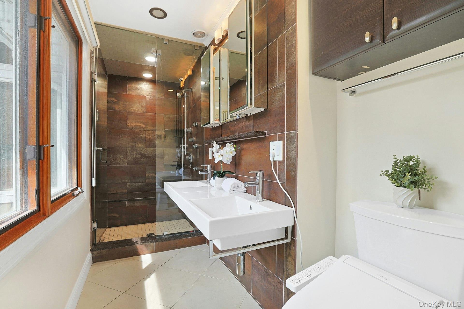 45 Sprain Valley Road Scarsdale, NY 10583 - Photo 12 of 26 Updated primary ensuite bath features double sinks and a large steam shower.