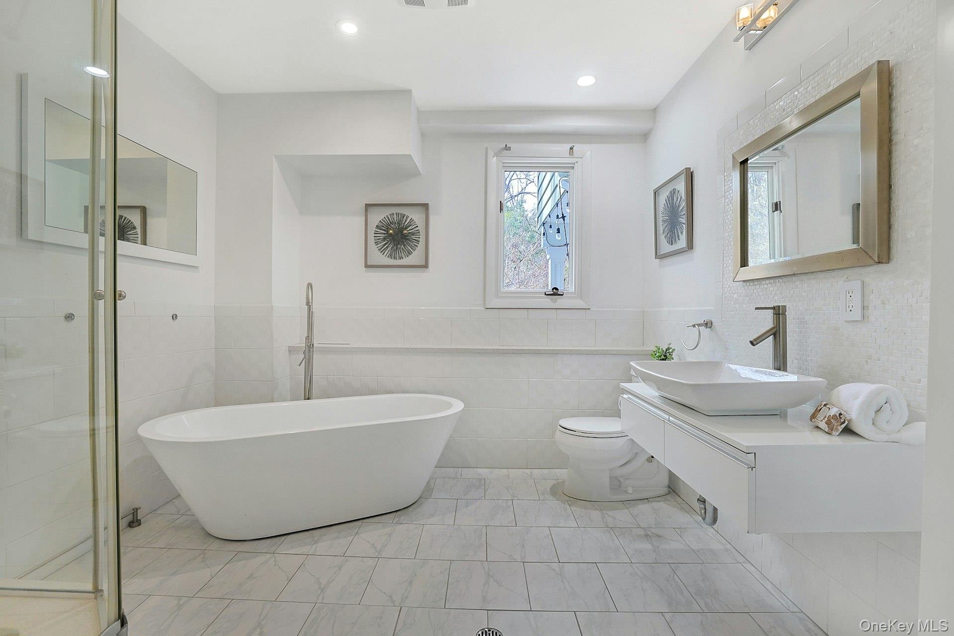 45 Sprain Valley Road Scarsdale, NY 10583 - Photo 19 of 26 Lower level hall bath complete with soaking tub, separate shower, and vanity, ideal for guests, extended family or work-from-home needs.