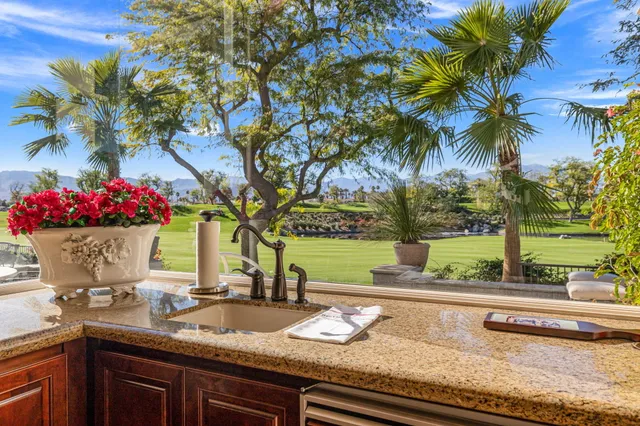 a bathroom with a granite countertop sink a mirror and shower