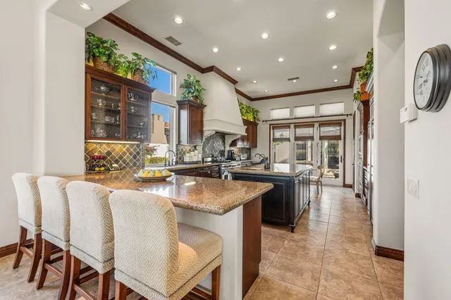 a living room with furniture and floor to ceiling window