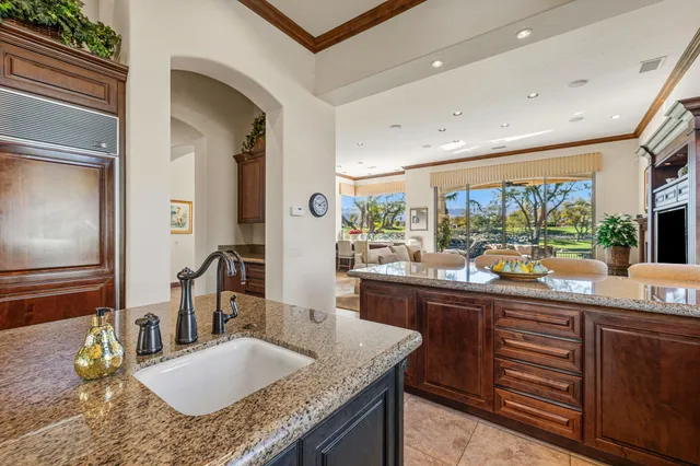 a bedroom with a bed flat screen tv and a fireplace