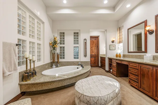 a view of a patio with couches table and chairs and potted plants
