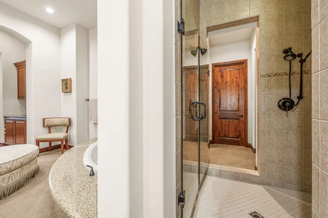 a view of patio with couches and table under an umbrella