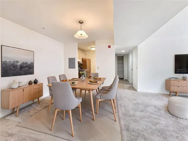 a view of a dining room with furniture and a flat screen tv