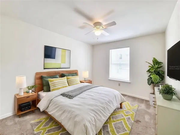 a bedroom with a bed and a chandelier