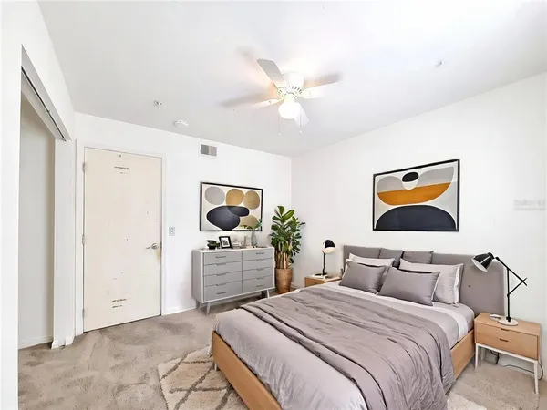 a bedroom with bed and a chandelier