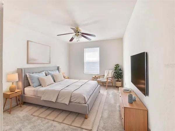 a bedroom with a bed and a flat screen tv