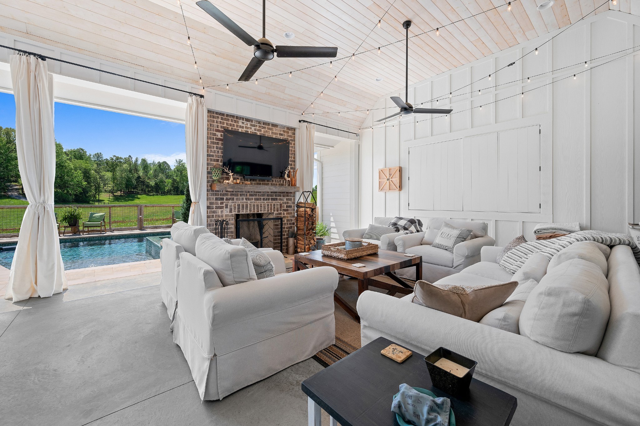 a living room with furniture a fireplace and a flat screen tv
