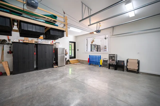an aerial view of residential houses with outdoor space and trees