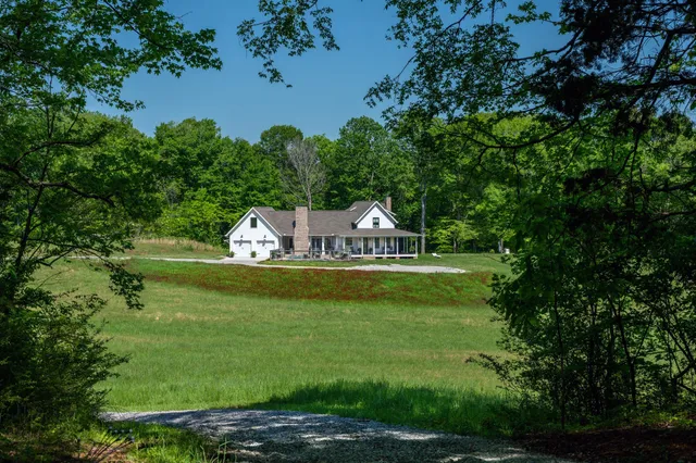 a view of a house with a backyard and a patio