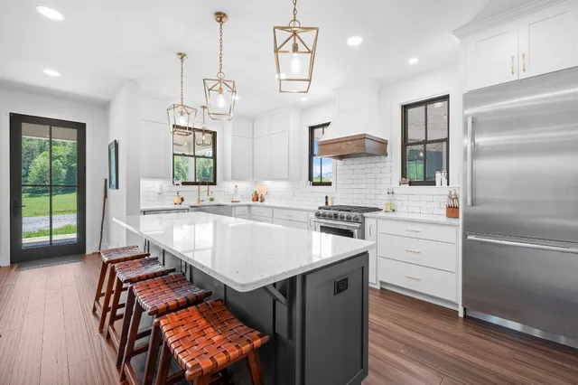 a kitchen with a sink appliances and cabinets