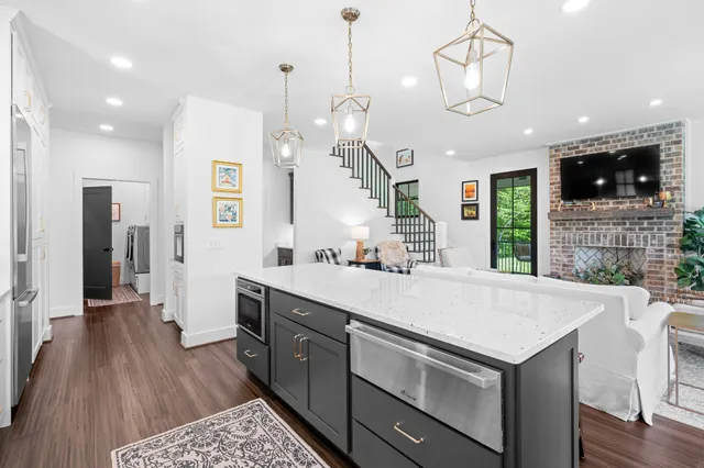 a living room with fireplace furniture and a flat screen tv