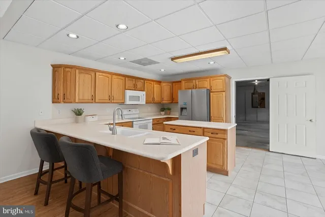 a kitchen with a sink a counter top space and stainless steel appliances
