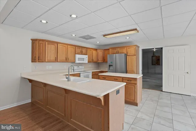 a kitchen with a sink cabinets and wooden floor