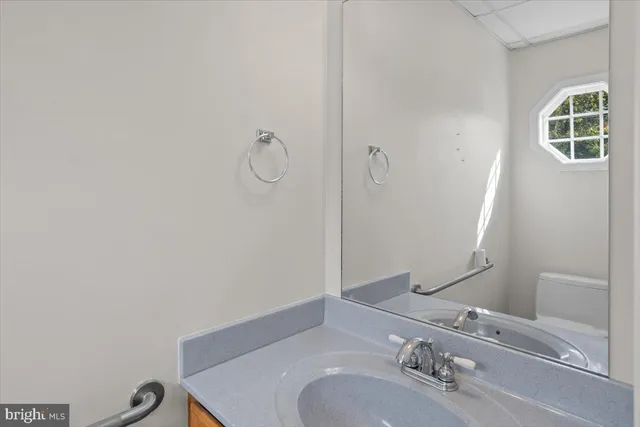 a bathroom with a sink vanity and a mirror