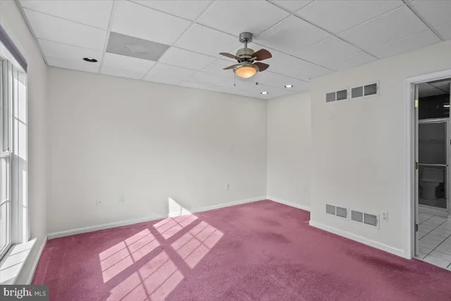 a bedroom with a bed and a chandelier fan