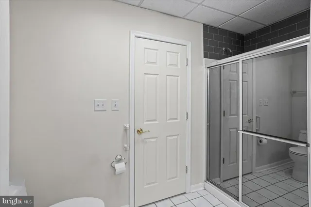 a bathroom with a granite countertop shower