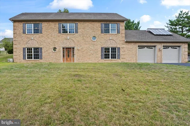 a house that has a large pool in front of it