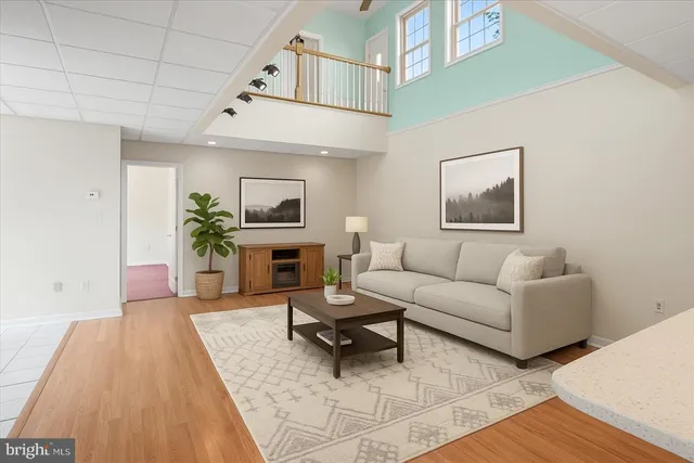 a living room with furniture a fireplace and a table