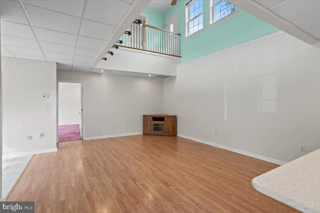 a view of a room with wooden floor