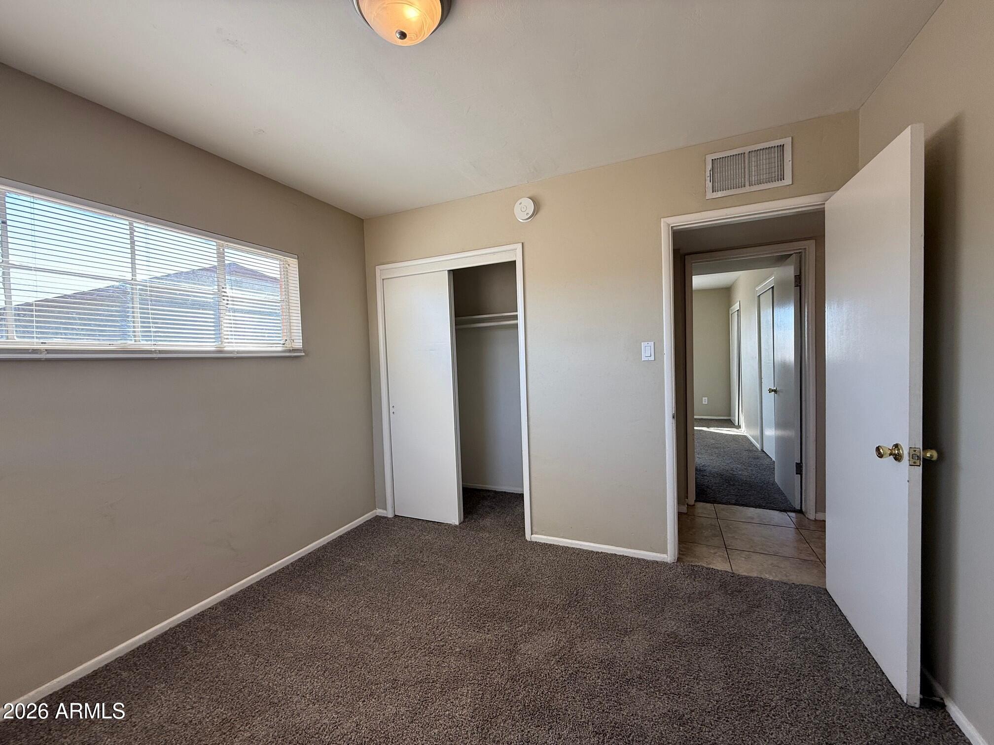 4447 East Almeria Road Phoenix, AZ 85008 - Photo 8 of 9 an empty room with windows and closet