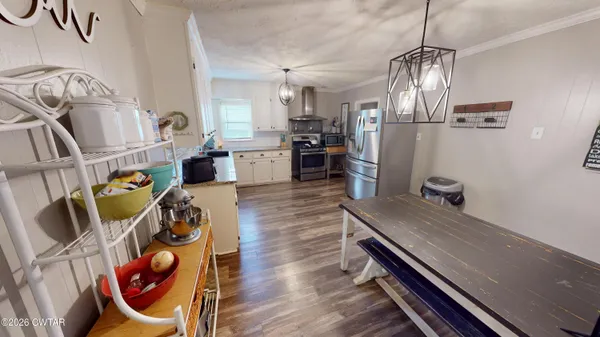a kitchen with sink refrigerator and stove