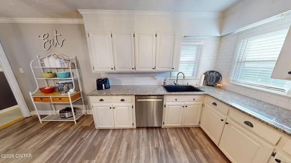 a kitchen with stainless steel appliances granite countertop a sink and cabinets