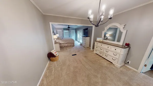 a view of living room with furniture and a chandelier