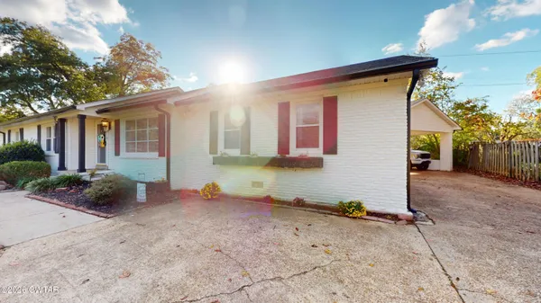 a view of a house with wooden fence