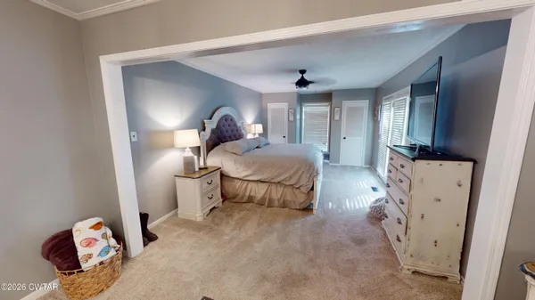 a bedroom with a bed and a mirror