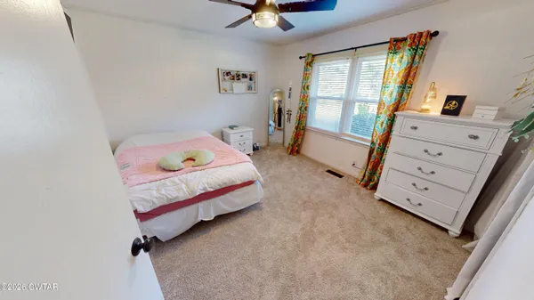 a bedroom with a bed and a window